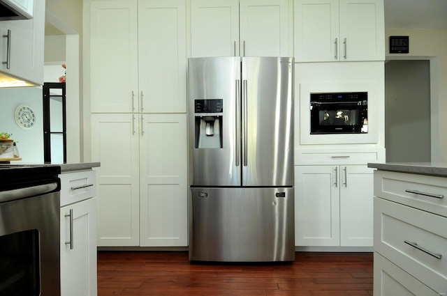 kitchen featuring extractor fan, white cabinetry, stainless steel appliances, and dark hardwood / wood-style flooring