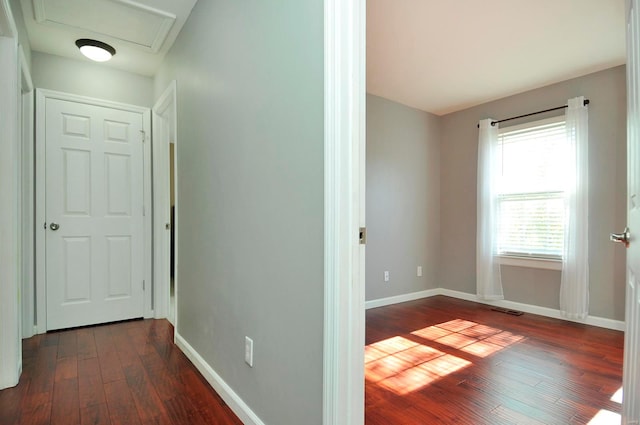 corridor with dark hardwood / wood-style flooring