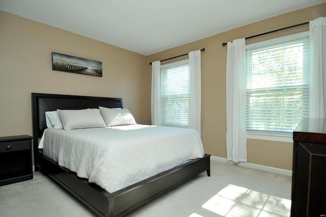 carpeted bedroom with multiple windows