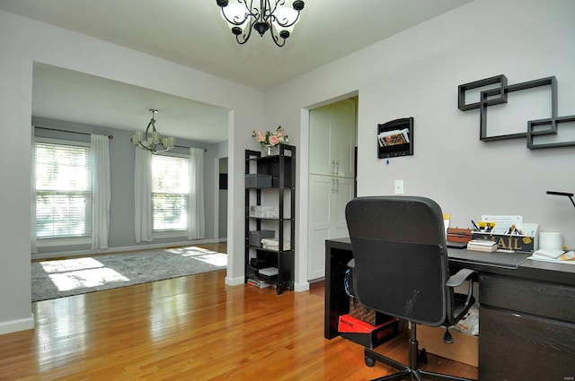 office area featuring light hardwood / wood-style floors and an inviting chandelier