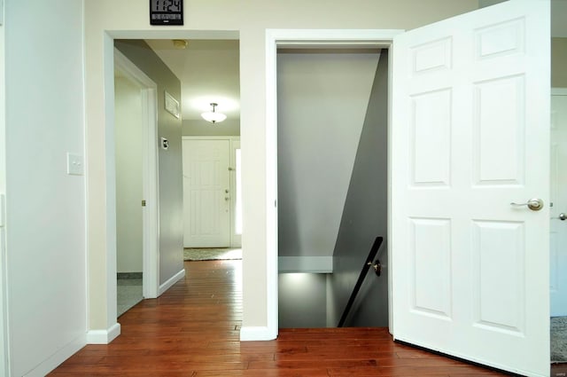 hallway with dark hardwood / wood-style flooring