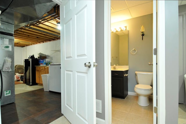 interior space with vanity, toilet, and tile patterned floors