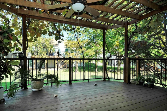 wooden terrace with ceiling fan and a pergola