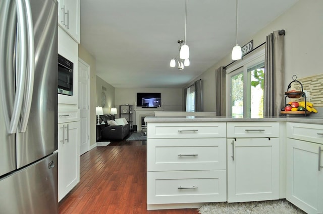 kitchen featuring white cabinetry, stainless steel refrigerator, pendant lighting, and dark wood-type flooring