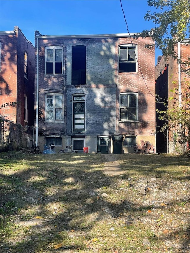 rear view of property with a lawn