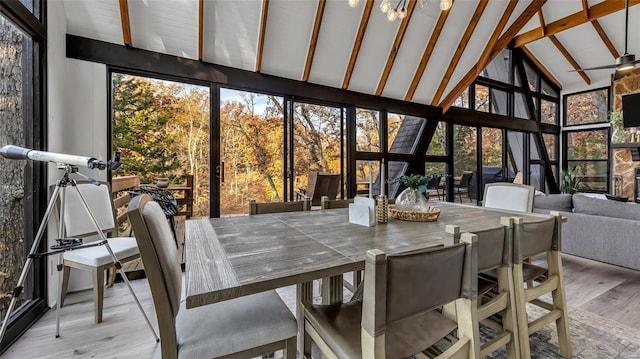 sunroom featuring vaulted ceiling with beams