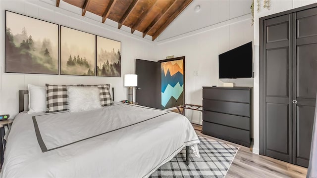 bedroom featuring light hardwood / wood-style floors, lofted ceiling, and wooden ceiling