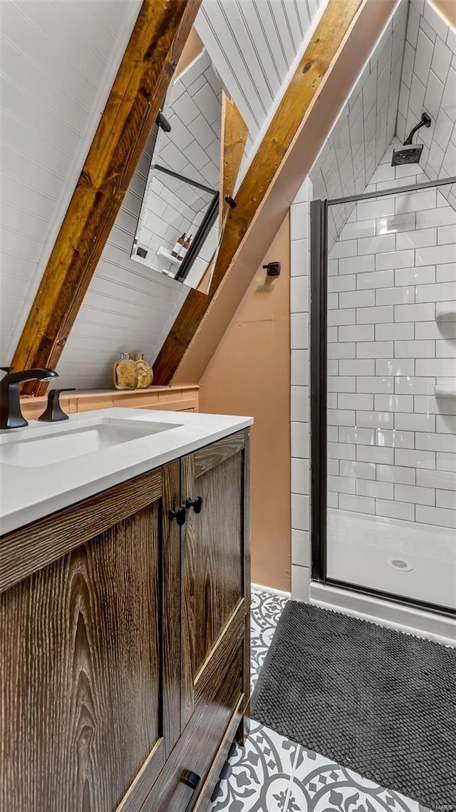 bathroom featuring vanity and a shower with shower door