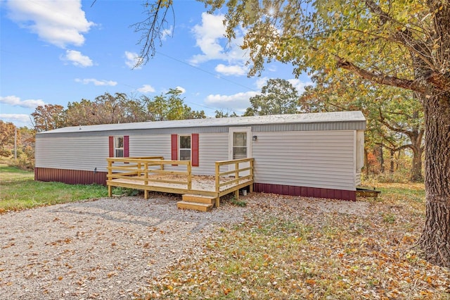 rear view of property featuring a deck