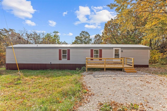 view of front facade featuring a deck and a front lawn