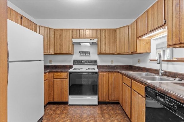 kitchen featuring white appliances, sink, and dark tile patterned flooring