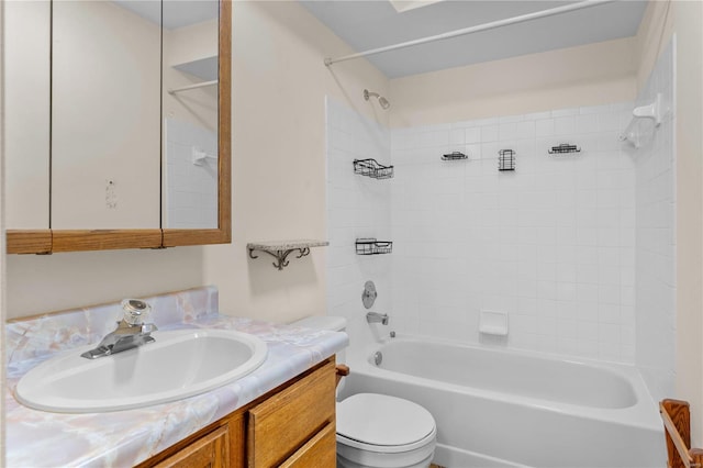 full bathroom with vanity, toilet, and tiled shower / bath