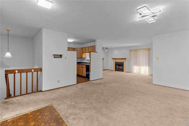 unfurnished living room featuring carpet and a tile fireplace