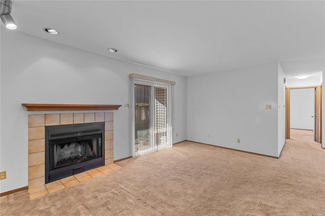 unfurnished living room with a fireplace and light colored carpet