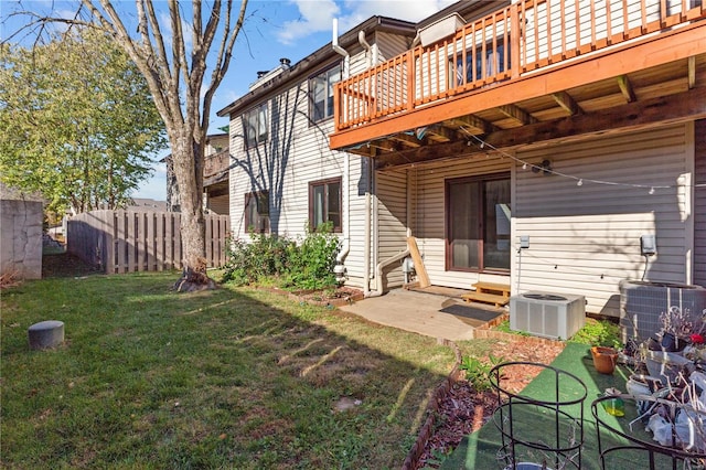 exterior space with a yard, a patio area, and cooling unit