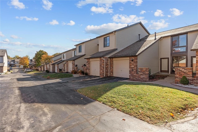 view of front of house with a garage and a front lawn