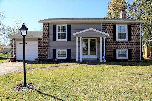 split foyer home with a front lawn and a garage