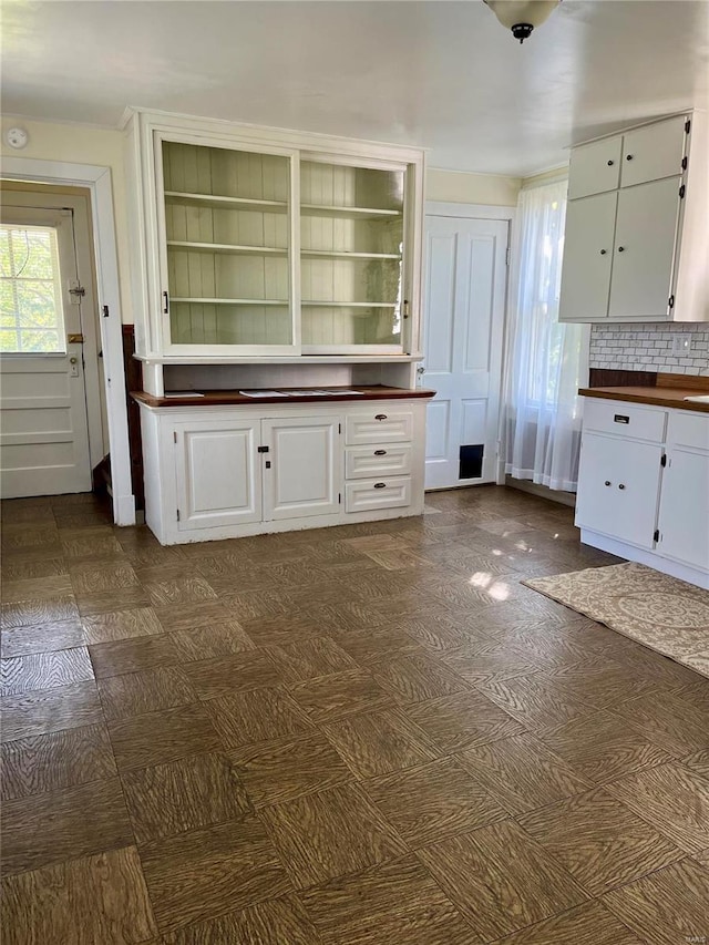 kitchen featuring white cabinets and backsplash