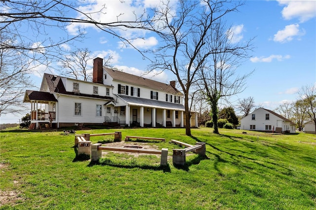 back of house featuring a lawn