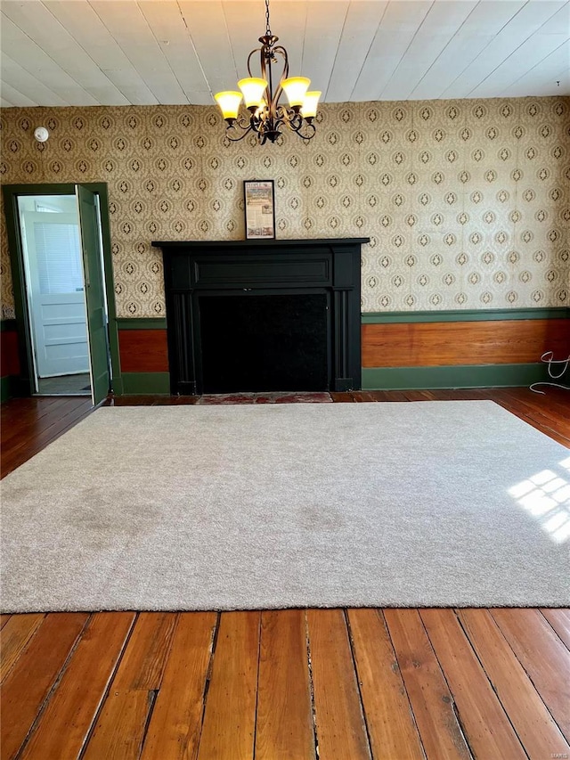 interior space featuring dark hardwood / wood-style flooring and an inviting chandelier