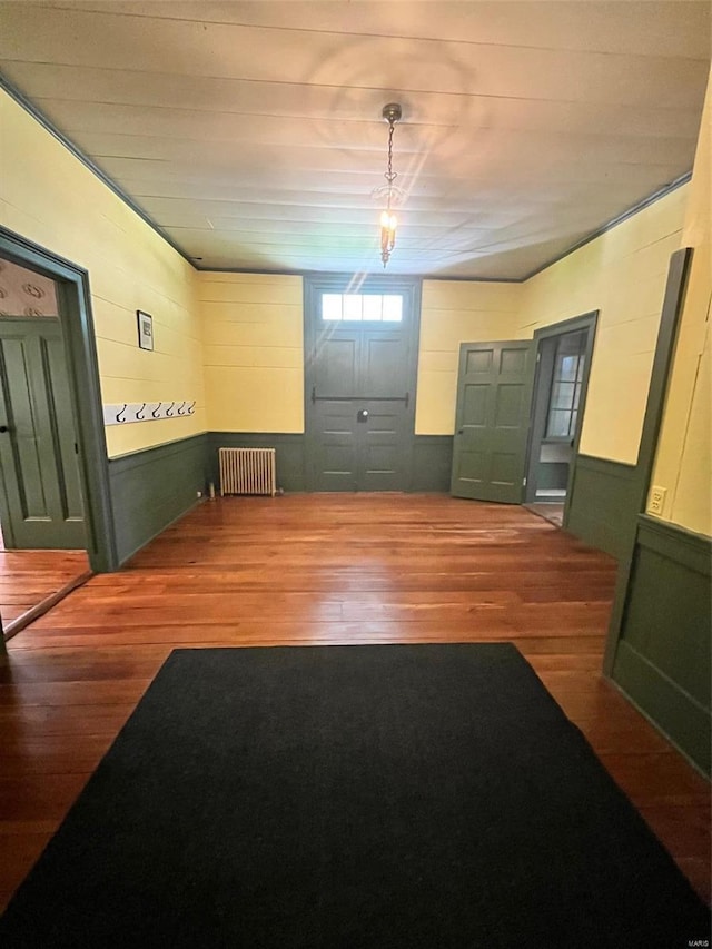 entrance foyer featuring radiator heating unit and dark wood-type flooring