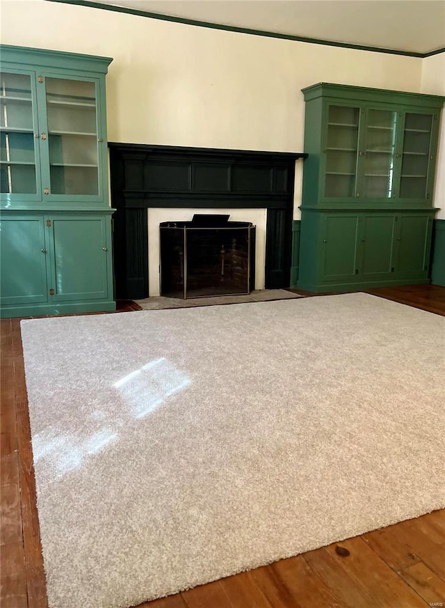 unfurnished living room with dark wood-type flooring