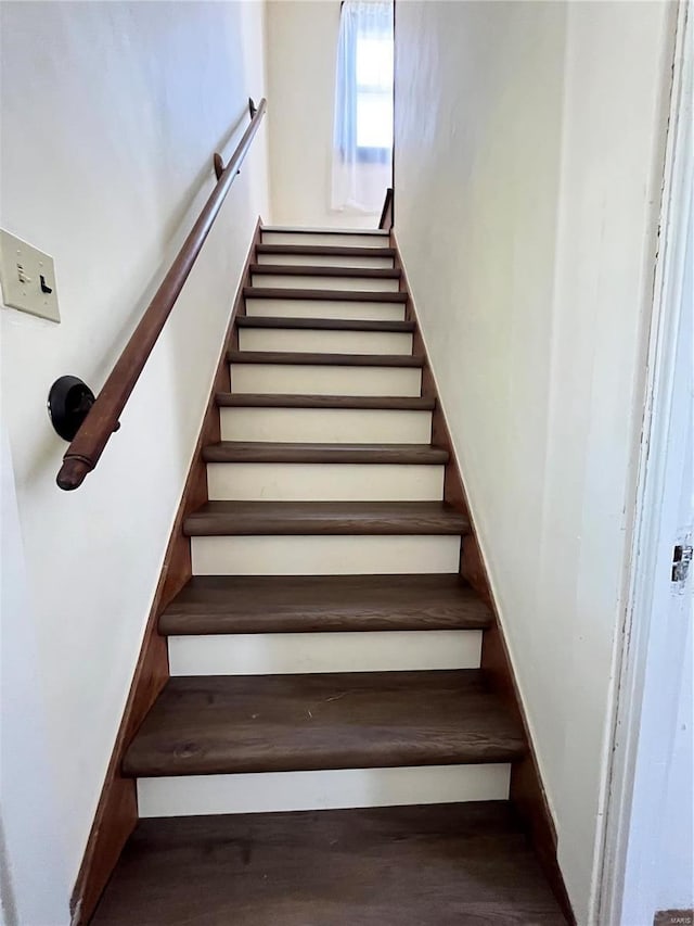 staircase with hardwood / wood-style floors