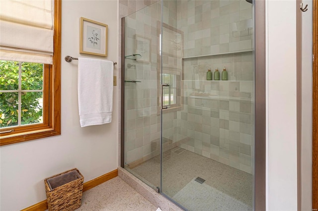 bathroom with a shower with door