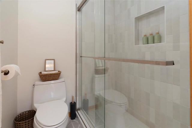 bathroom featuring toilet and walk in shower