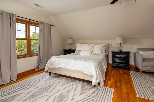 bedroom featuring hardwood / wood-style floors, ceiling fan, and vaulted ceiling