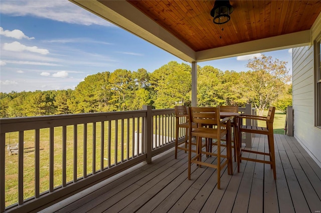 wooden deck featuring a yard