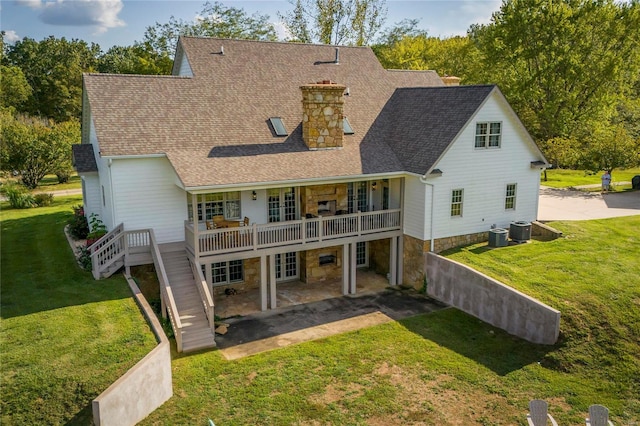 rear view of house featuring a yard, a patio area, and central air condition unit