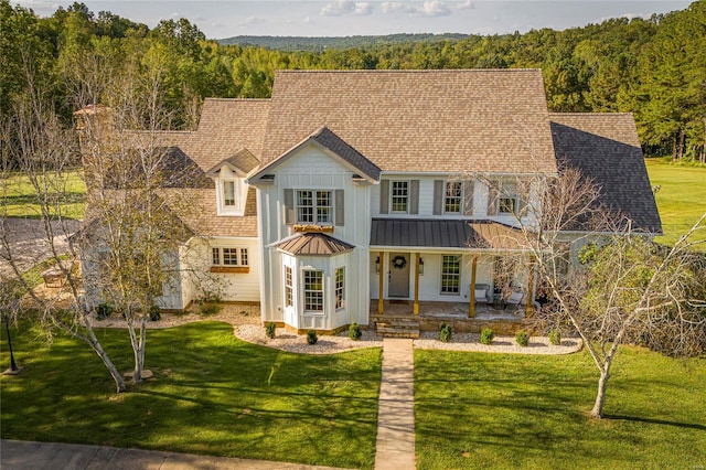 view of front of home with covered porch and a front yard