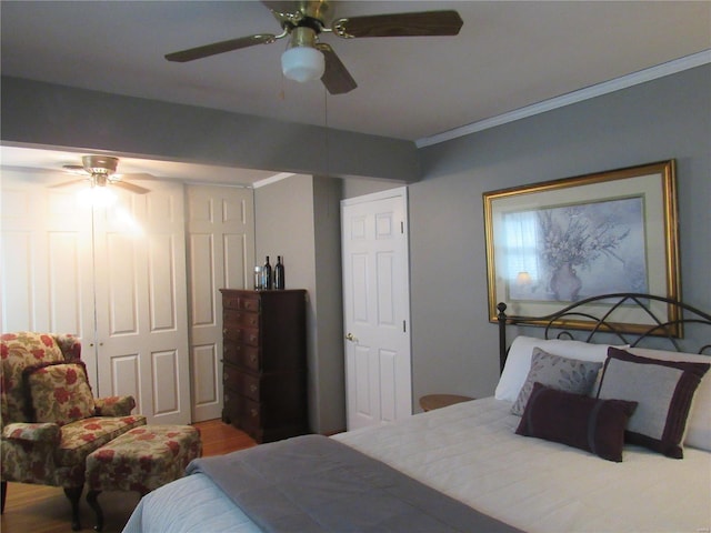 bedroom featuring crown molding, hardwood / wood-style flooring, and ceiling fan