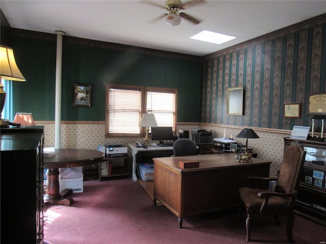 carpeted home office with a skylight and ceiling fan