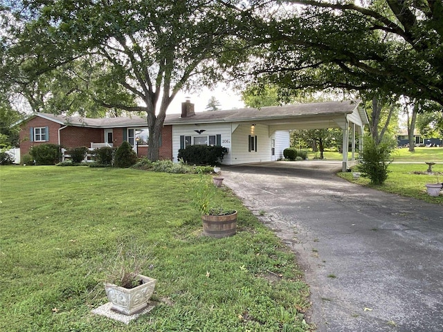 ranch-style house with a front yard and a carport