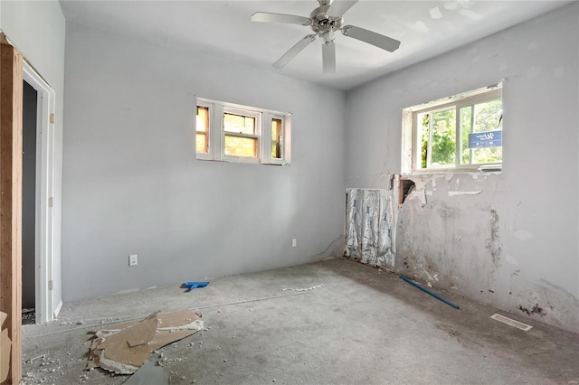 unfurnished room featuring ceiling fan and plenty of natural light