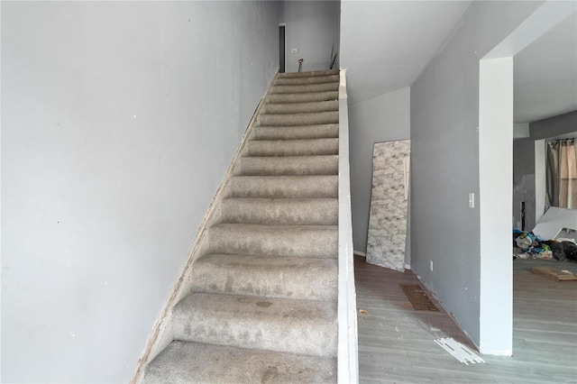 stairs featuring hardwood / wood-style flooring