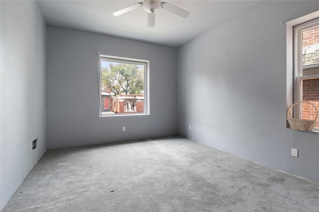 carpeted empty room featuring ceiling fan