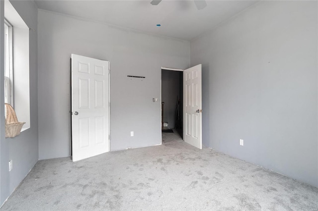 unfurnished bedroom featuring ceiling fan and light colored carpet