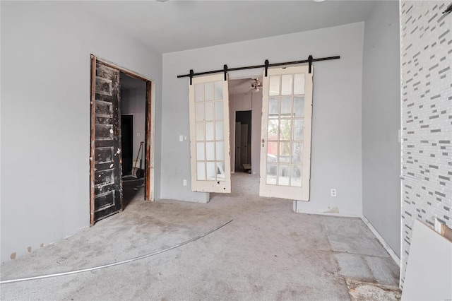 carpeted empty room featuring french doors and ceiling fan