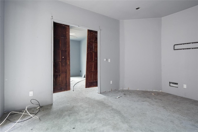 spare room featuring light colored carpet