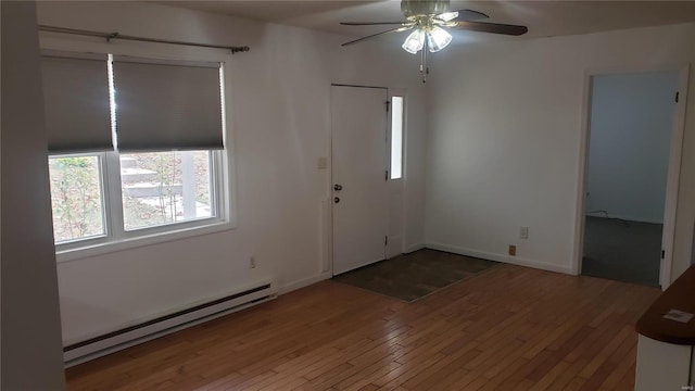 entrance foyer with a ceiling fan, baseboards, hardwood / wood-style flooring, and a baseboard radiator