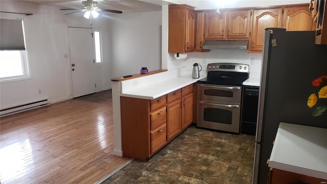kitchen featuring a ceiling fan, appliances with stainless steel finishes, light countertops, a peninsula, and under cabinet range hood