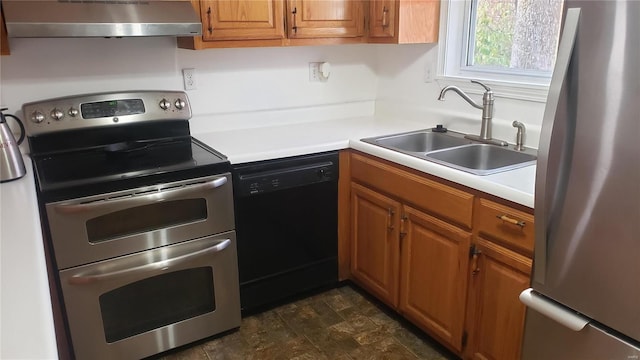 kitchen featuring a sink, light countertops, brown cabinetry, stainless steel appliances, and range hood