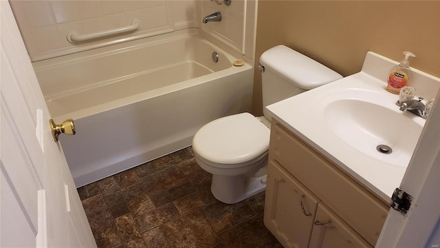 bathroom featuring vanity, toilet, and stone tile floors
