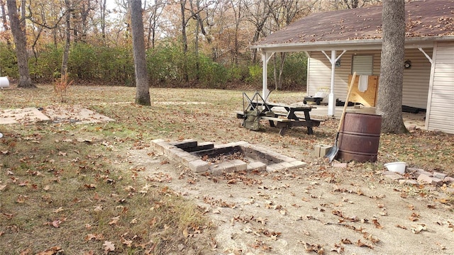 view of yard featuring an outdoor fire pit and a patio area