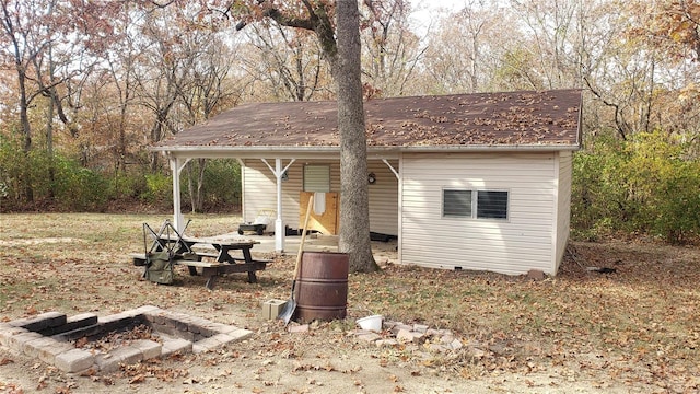 exterior space featuring an outdoor fire pit