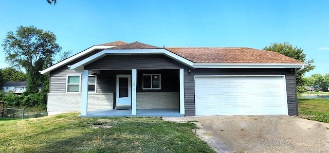 view of front facade with a front yard and a garage