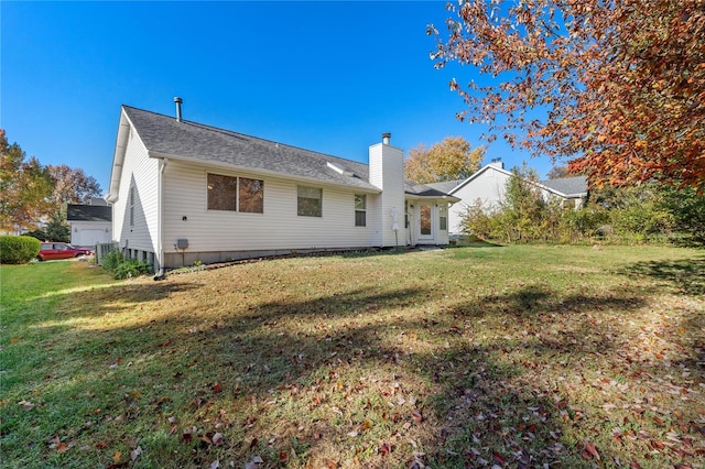 rear view of property with a yard